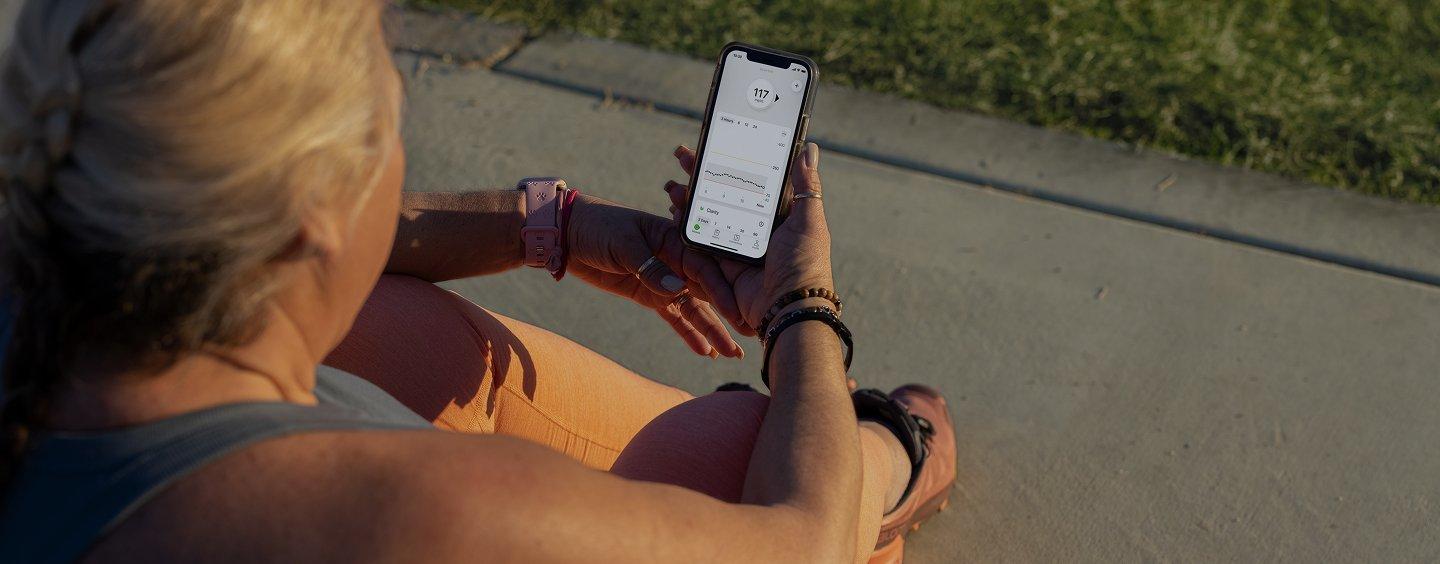 Dexcom CGM user examining results on phone